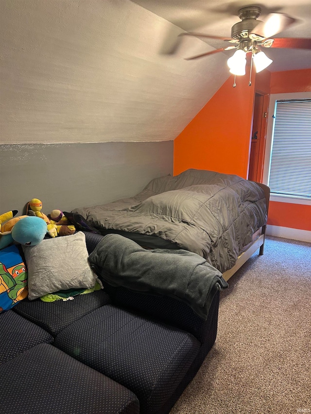 bedroom featuring lofted ceiling, ceiling fan, and carpet flooring