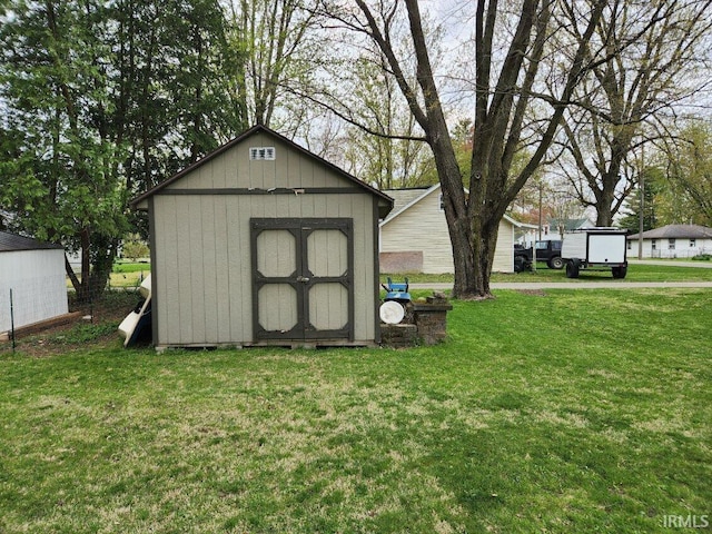 view of outdoor structure featuring a lawn