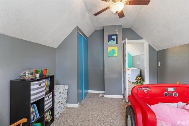 bedroom with lofted ceiling, carpet flooring, ceiling fan, and a textured ceiling