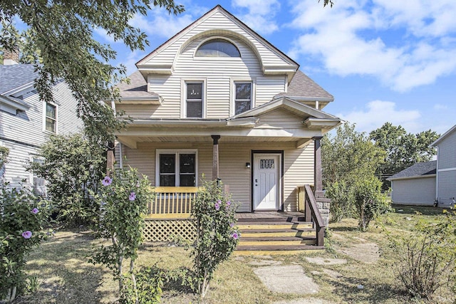 view of front of property featuring covered porch and roof with shingles