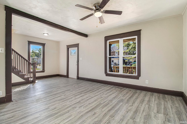 unfurnished room featuring light wood-type flooring and ceiling fan