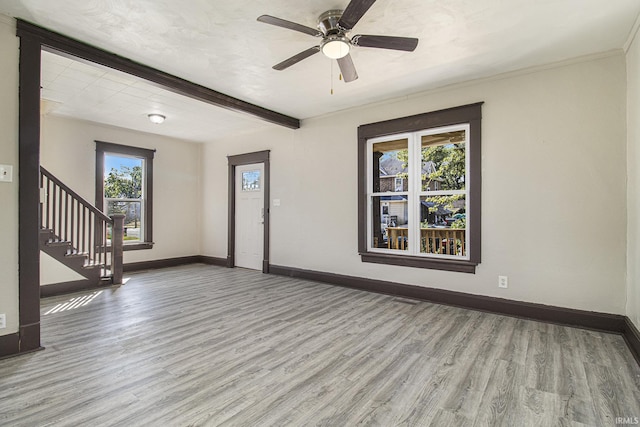 entryway featuring stairway, wood finished floors, and baseboards