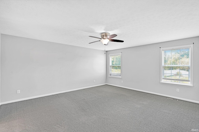 carpeted spare room with ceiling fan and a textured ceiling