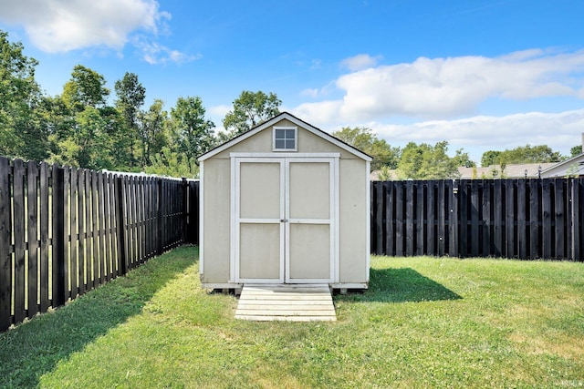 view of shed with a fenced backyard