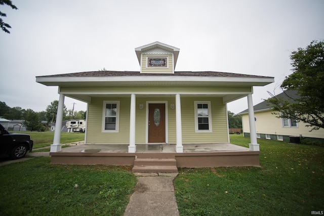 bungalow-style home featuring a porch and a front lawn