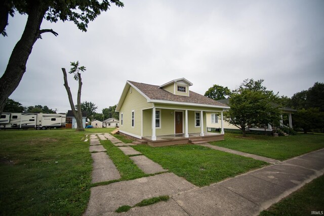 bungalow-style home featuring a front lawn and covered porch