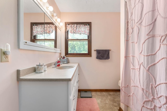 bathroom with vanity, toilet, a shower with curtain, and tile patterned floors