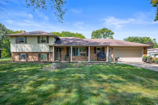 tri-level home featuring a garage and a front lawn