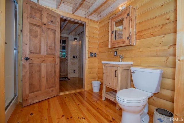 bathroom with toilet, a stall shower, wood ceiling, vanity, and wood finished floors