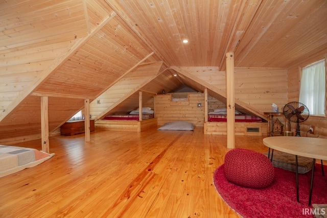 additional living space featuring vaulted ceiling, wood walls, wood-type flooring, and wood ceiling