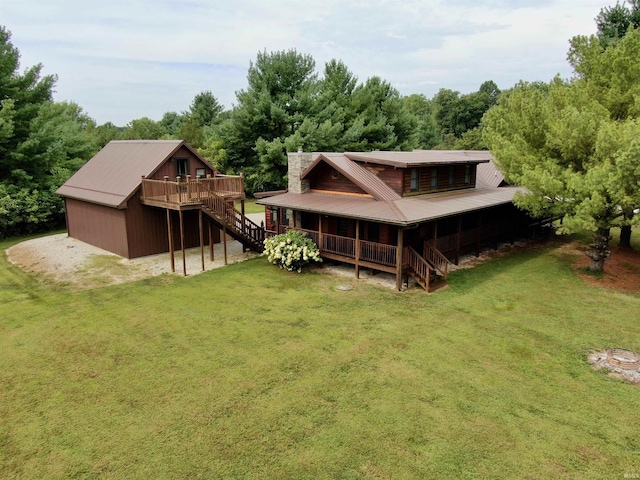 back of house with stairs, metal roof, a lawn, and a wooden deck