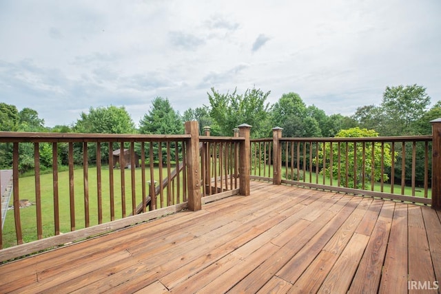 wooden terrace featuring a lawn