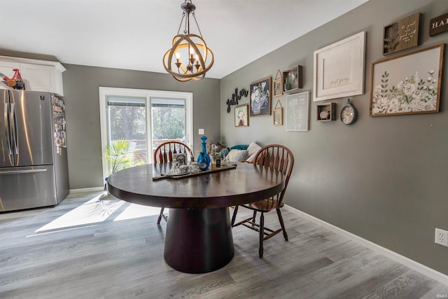 dining area featuring hardwood / wood-style floors and a chandelier