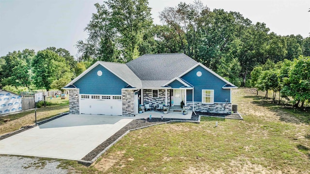 view of front of home with a front lawn and a garage