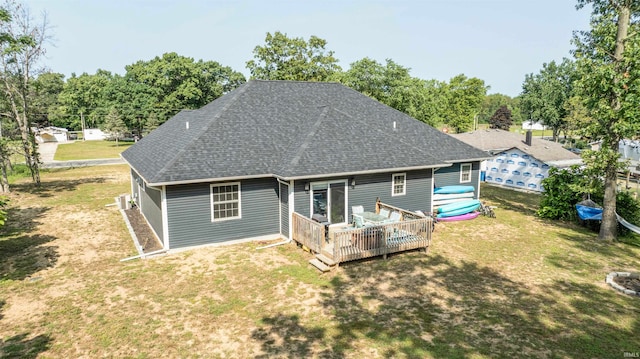 back of house with a yard and a deck