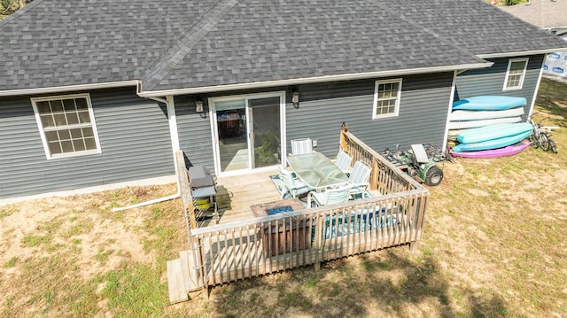 back of house featuring a yard and a deck