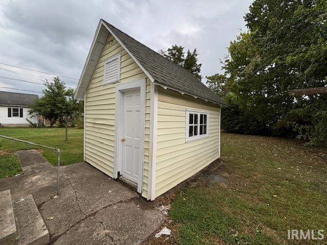 view of outbuilding featuring a lawn