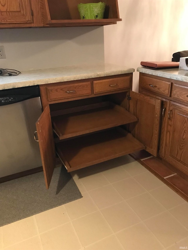 kitchen featuring brown cabinets, light countertops, and dishwasher