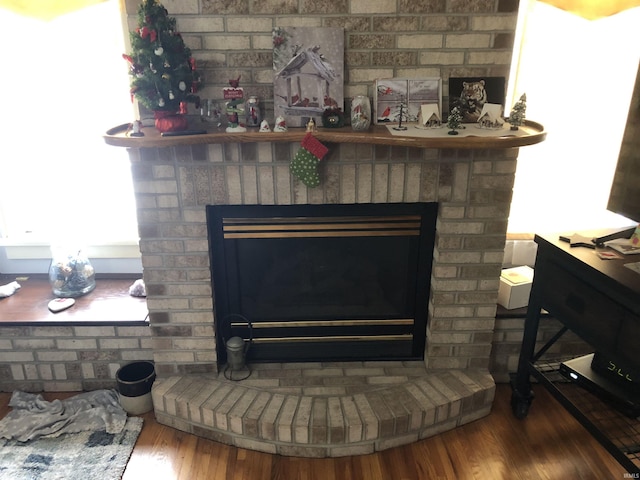 interior details with a fireplace and wood finished floors