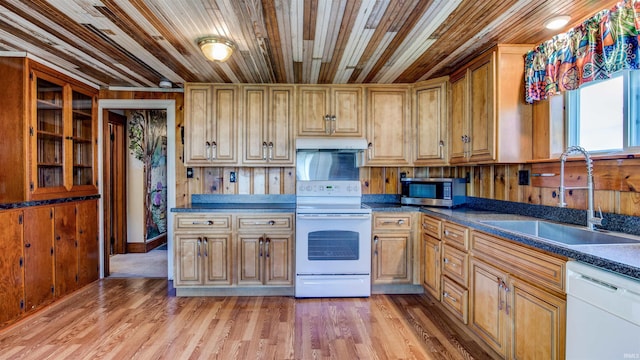 kitchen with wooden ceiling, white appliances, light hardwood / wood-style floors, sink, and wood walls