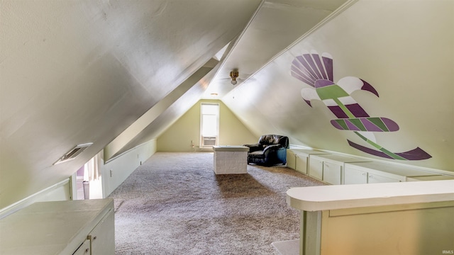 bonus room with lofted ceiling and light colored carpet