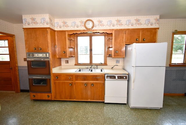 kitchen with white appliances, backsplash, and sink