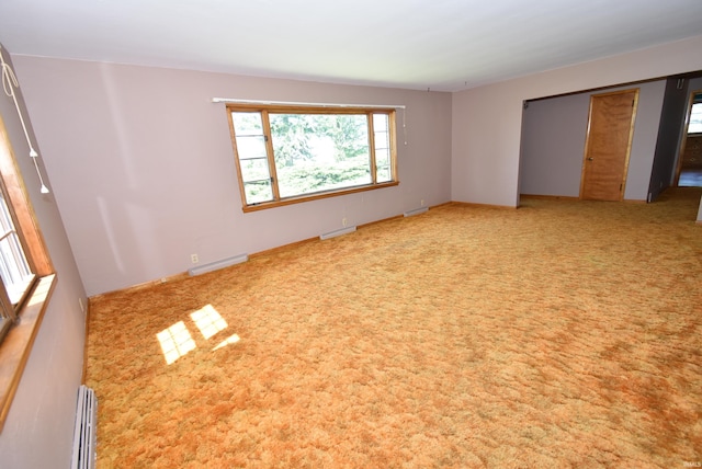 interior space with a baseboard heating unit, a closet, and carpet floors