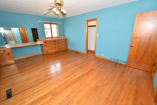 unfurnished bedroom with light wood-type flooring and ceiling fan