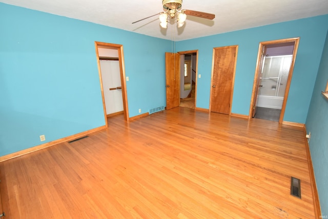 unfurnished bedroom featuring ceiling fan, light hardwood / wood-style floors, and ensuite bath