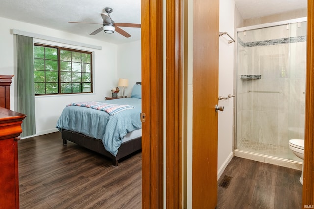 bedroom with ceiling fan, dark hardwood / wood-style floors, and a textured ceiling