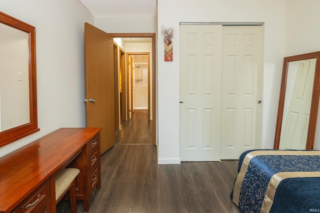 bedroom featuring a closet and dark hardwood / wood-style floors