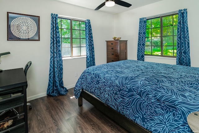 bedroom with ceiling fan and dark hardwood / wood-style flooring