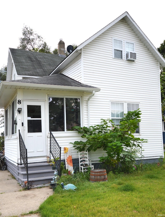 back of house with a lawn and cooling unit