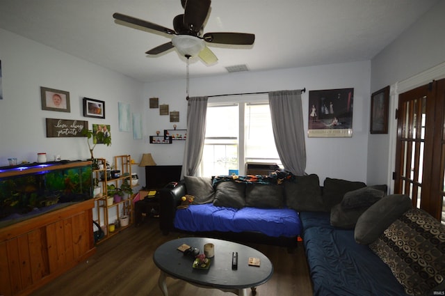 living room with ceiling fan, cooling unit, and dark wood-type flooring