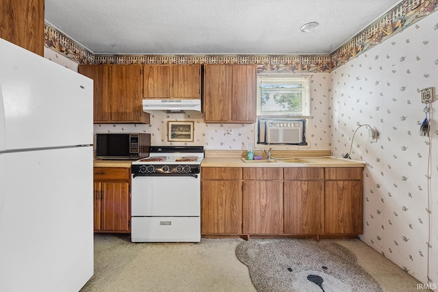 kitchen featuring cooling unit, white appliances, sink, and a textured ceiling