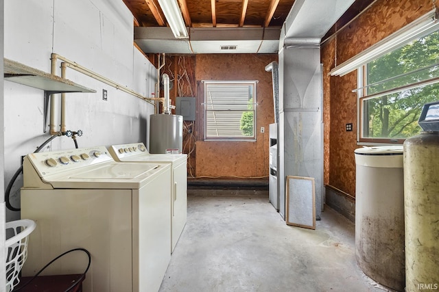 laundry room featuring a wealth of natural light, water heater, and washer and dryer