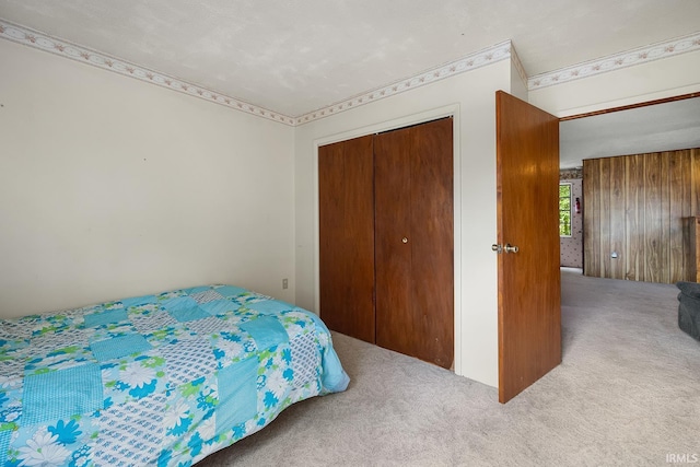 bedroom featuring a closet, carpet flooring, and a textured ceiling