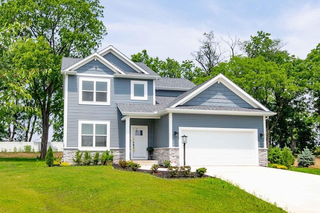 craftsman-style home featuring a garage and a front lawn