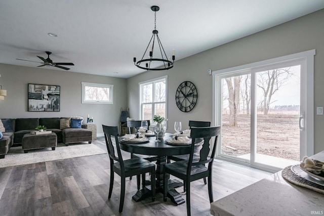 52520 E Trail Trail, South Bend, IN 46628 - dining room with wood finished floors, ceiling fan, a chandelier, and baseboards