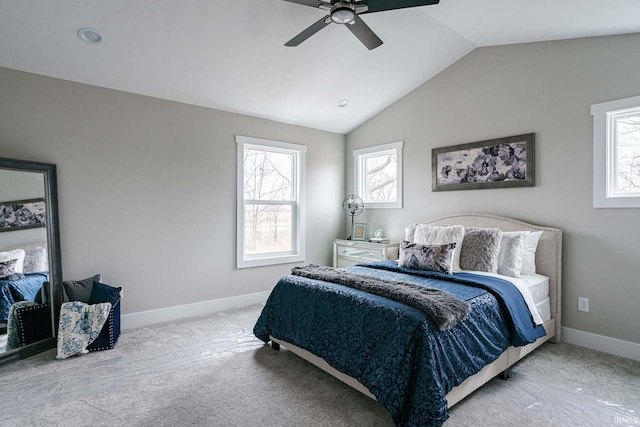 carpeted bedroom featuring multiple windows, vaulted ceiling, and ceiling fan