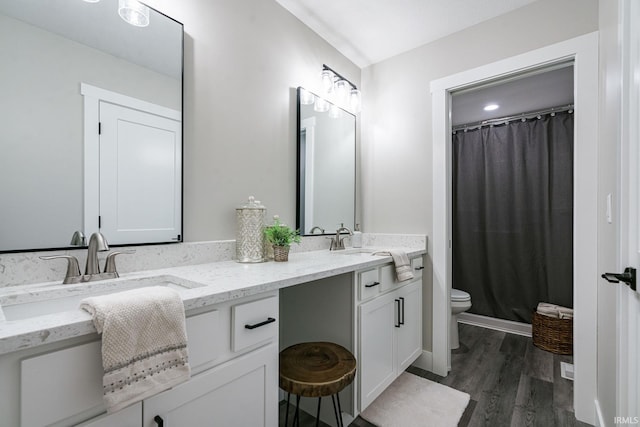 bathroom with a shower with curtain, wood-type flooring, toilet, and vanity