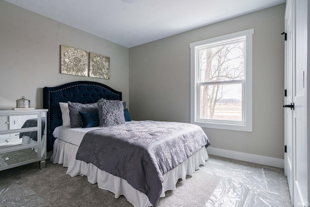 bedroom featuring multiple windows and carpet flooring