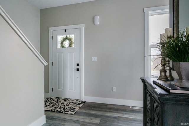 entryway with dark hardwood / wood-style flooring