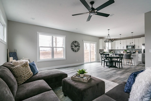 52520 E Trail Trail, South Bend, IN 46628 - living room featuring a ceiling fan, light wood-style floors, and baseboards