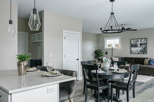 dining space with wood-type flooring