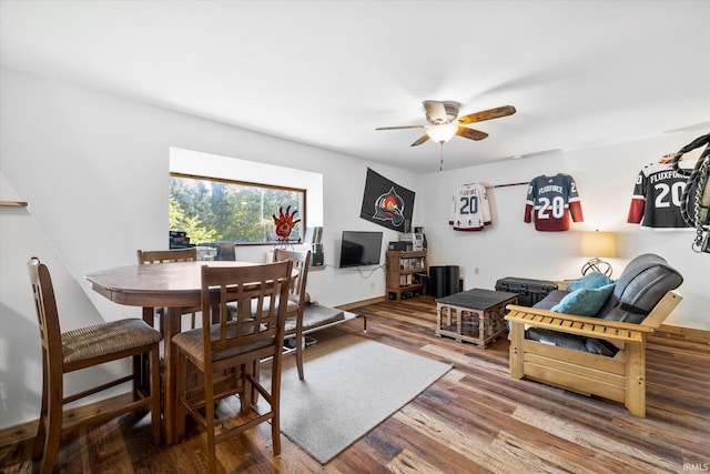 living room with dark hardwood / wood-style flooring and ceiling fan