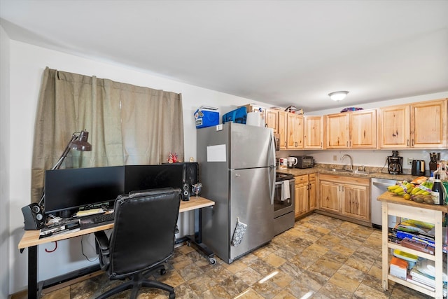 kitchen with stone finish floor, light countertops, stainless steel appliances, light brown cabinetry, and a sink