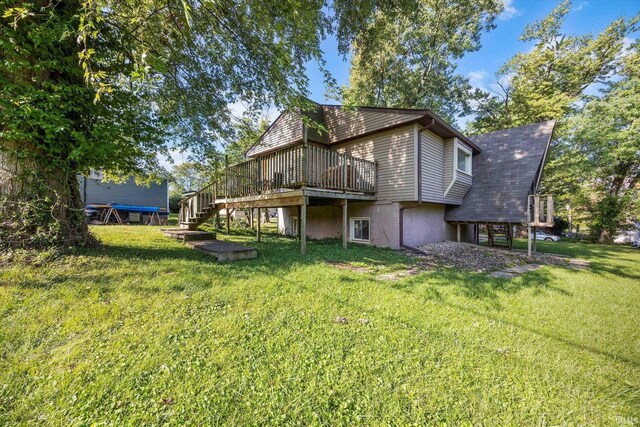 back of property with stairs, a lawn, and a wooden deck