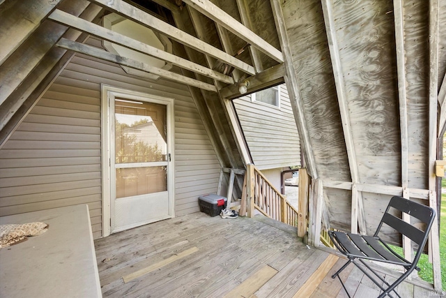 unfinished attic with an upstairs landing