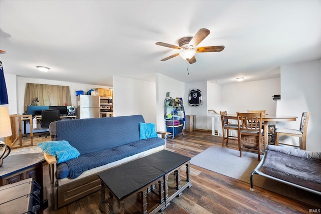 living room featuring a ceiling fan and wood finished floors